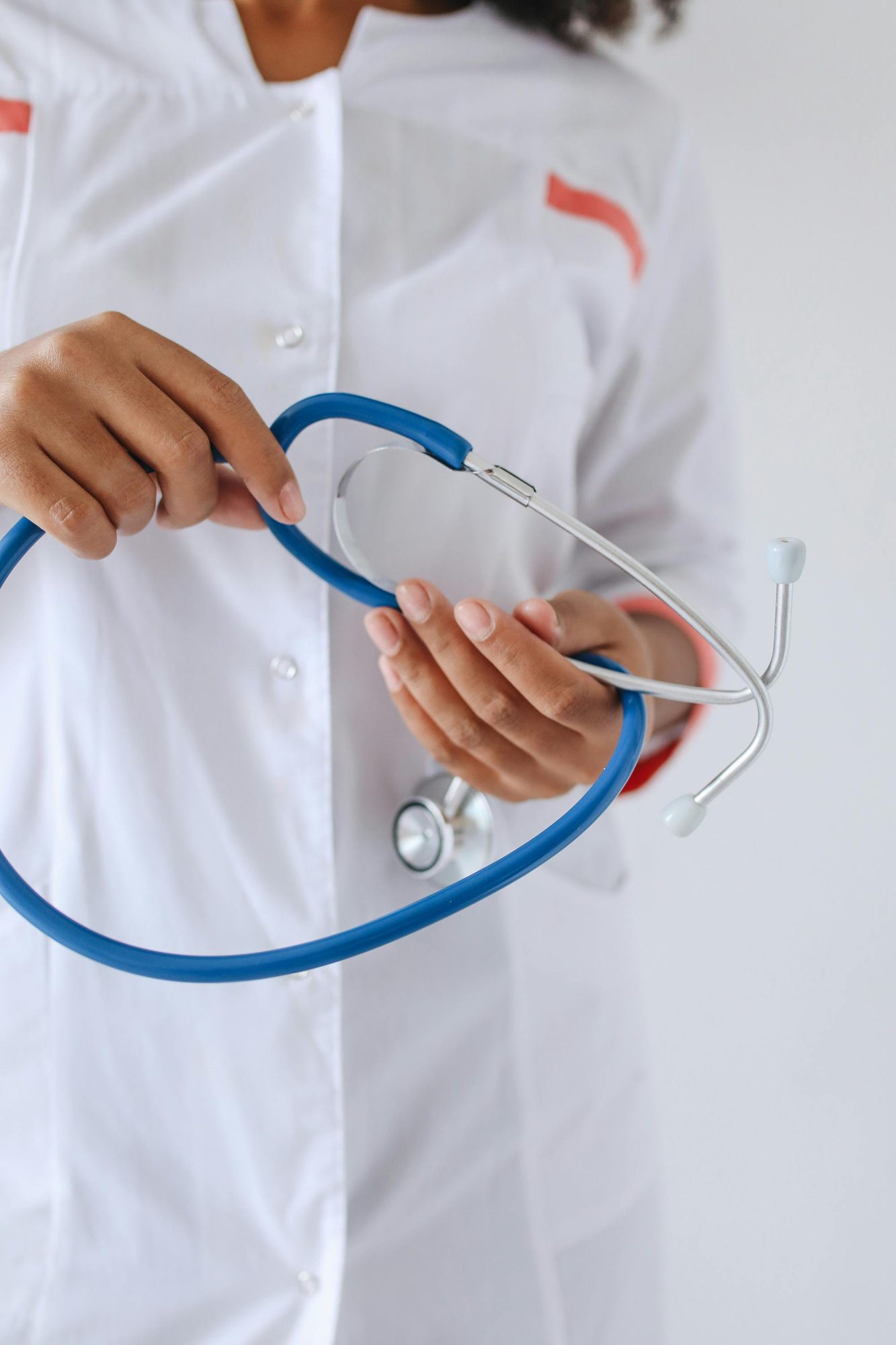 A nurse preparing a stethoscope before a visit